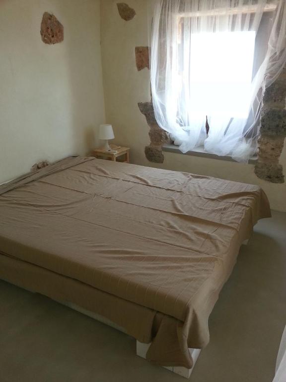 Postel nebo postele na pokoji v ubytování La Torre di Merlino