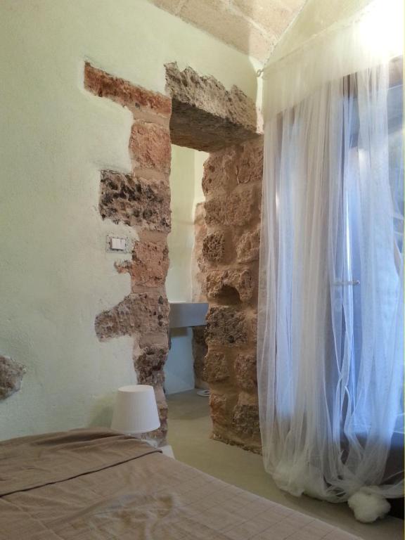 Postel nebo postele na pokoji v ubytování La Torre di Merlino