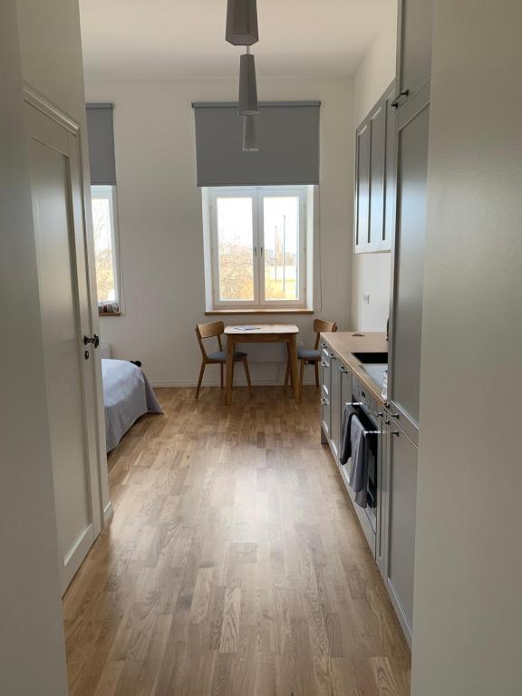 a room with a kitchen and a table in it at Piiri Apartment in Rakvere