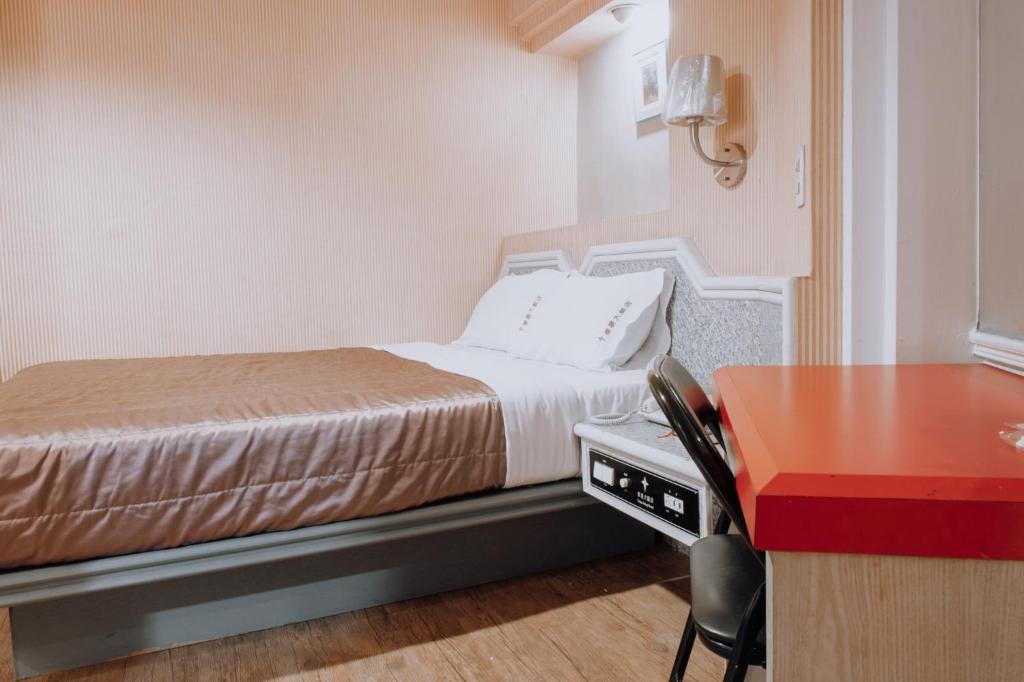 Postel nebo postele na pokoji v ubytování Tong Hsin Hotel