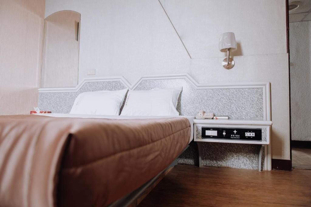 Postel nebo postele na pokoji v ubytování Tong Hsin Hotel