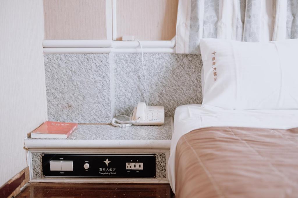 Postel nebo postele na pokoji v ubytování Tong Hsin Hotel
