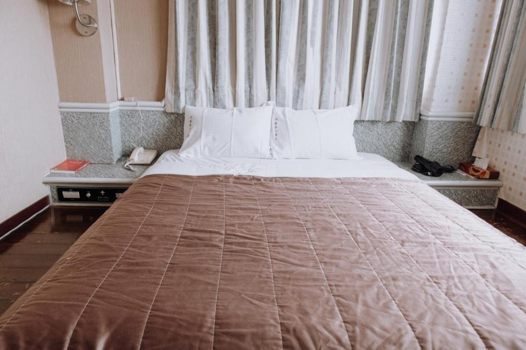 Postel nebo postele na pokoji v ubytování Tong Hsin Hotel