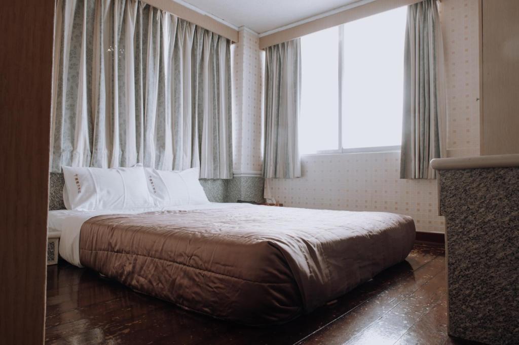 Postel nebo postele na pokoji v ubytování Tong Hsin Hotel