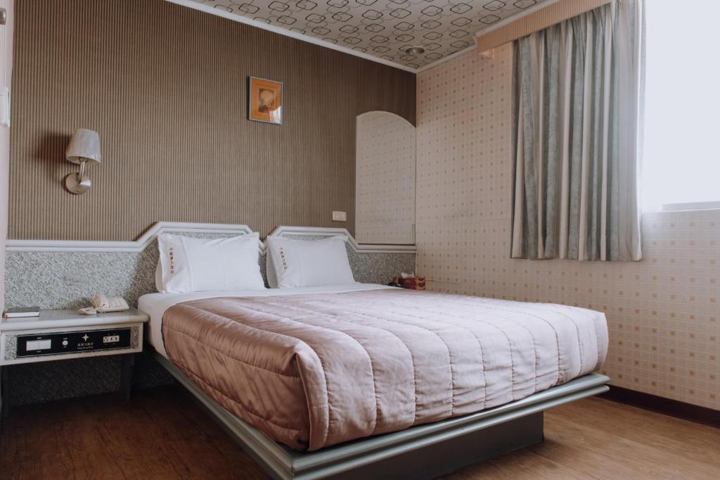 Postel nebo postele na pokoji v ubytování Tong Hsin Hotel
