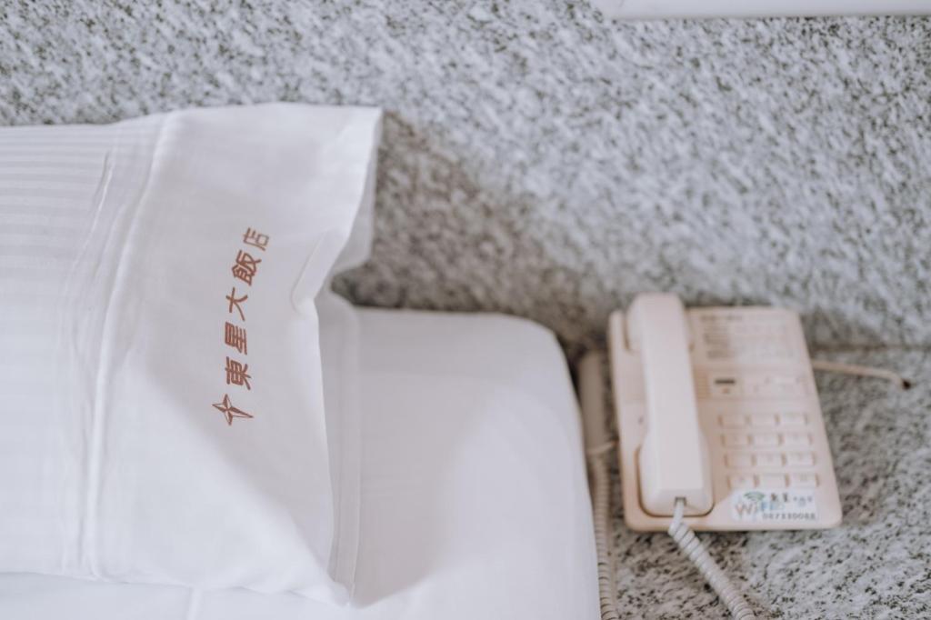 Postel nebo postele na pokoji v ubytování Tong Hsin Hotel