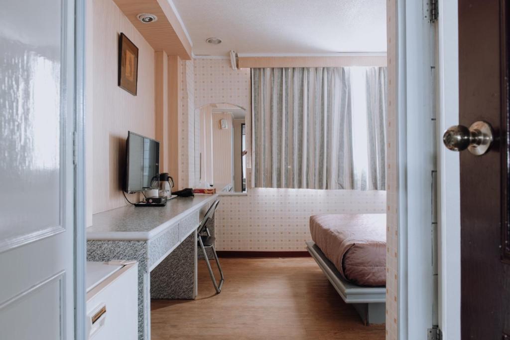 Postel nebo postele na pokoji v ubytování Tong Hsin Hotel