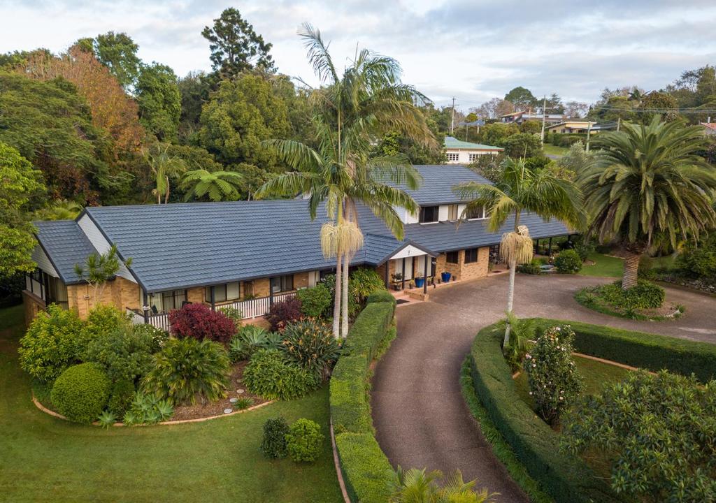 an aerial view of a house with a palm tree at Mountain Sanctuary B&B in Mount Tamborine