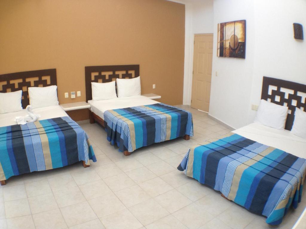 Una cama o camas en una habitación de Hotel Bahia Huatulco