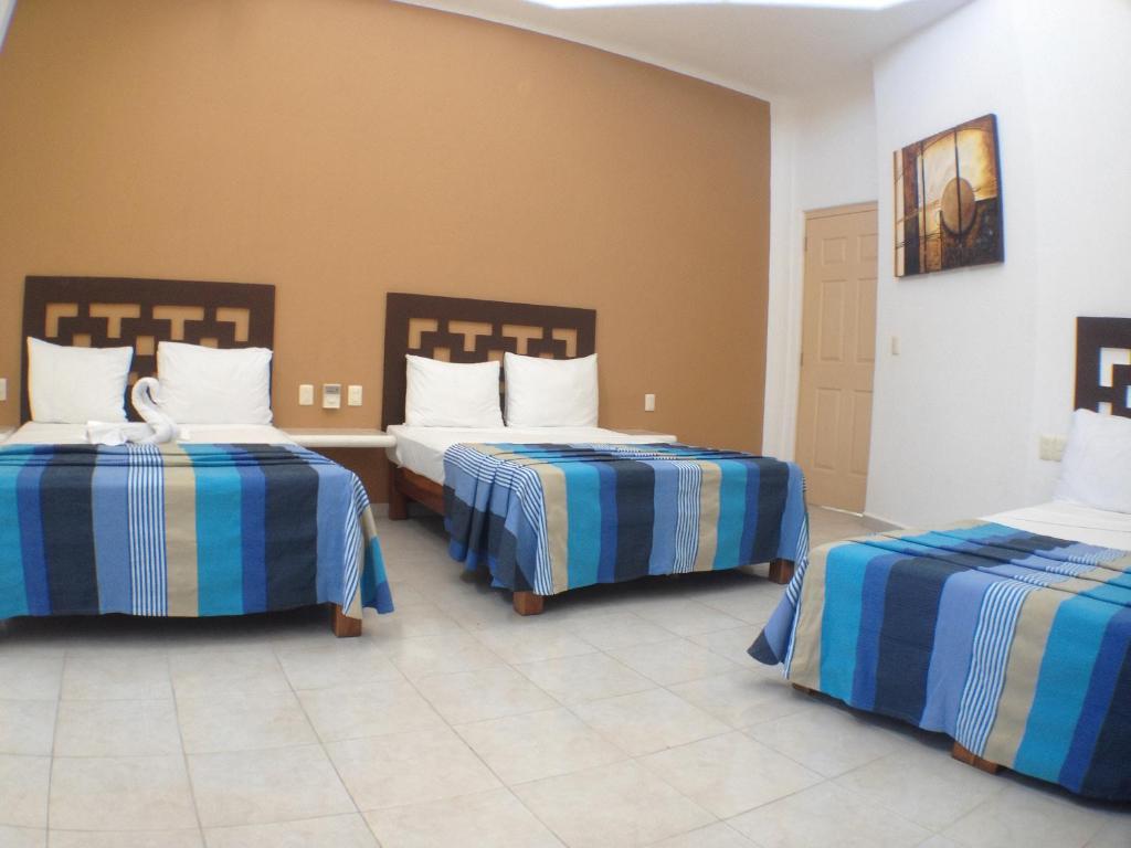 Una cama o camas en una habitación de Hotel Bahia Huatulco