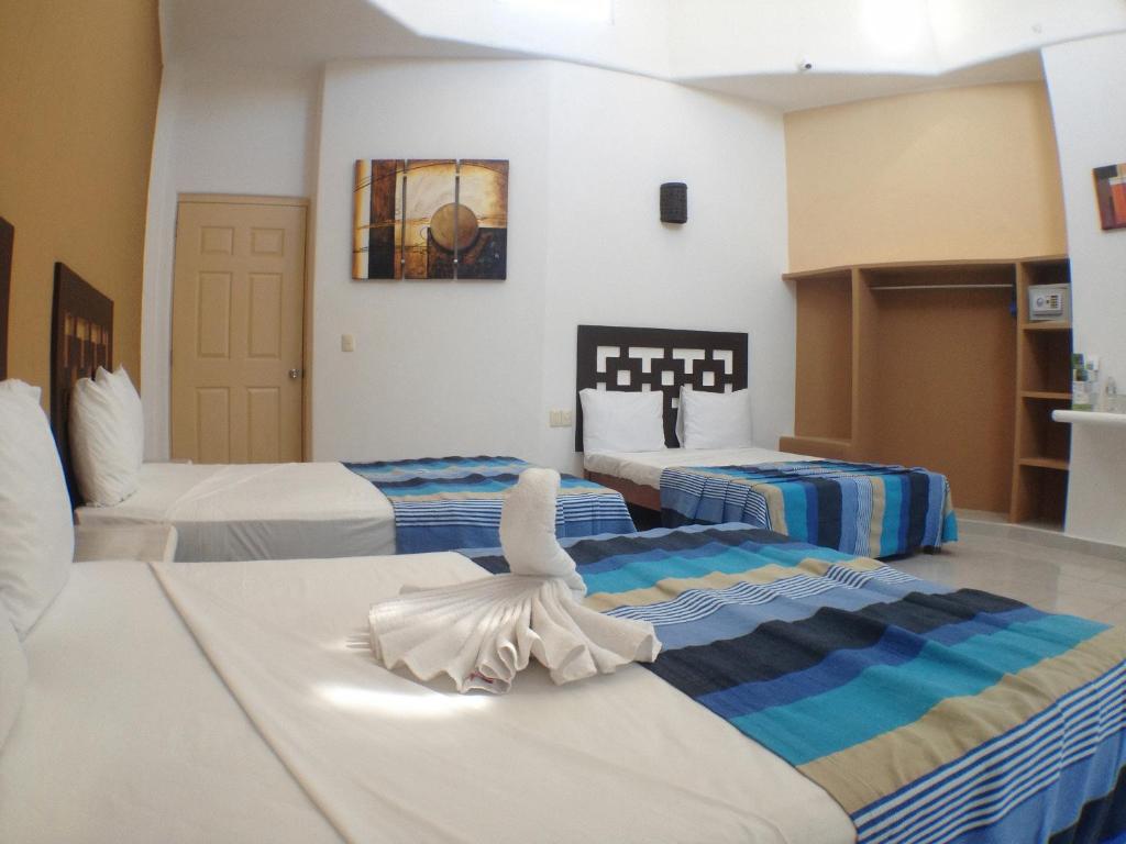 Una cama o camas en una habitación de Hotel Bahia Huatulco