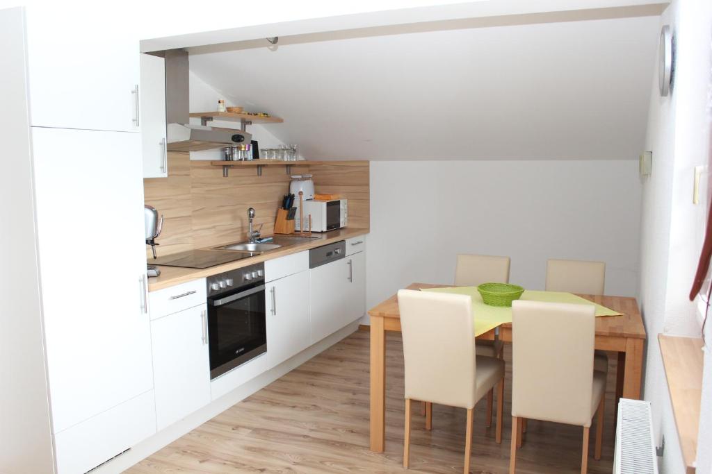 a kitchen with a table and chairs in a room at Apartments Kitzbühel in Kitzbühel