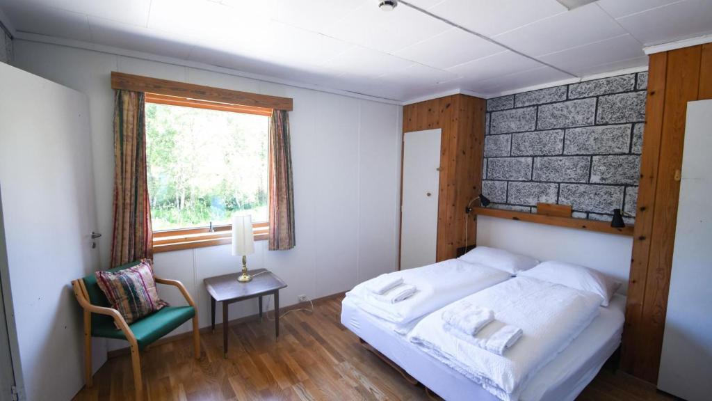 Postel nebo postele na pokoji v ubytování Voss Lodge Rongastovo