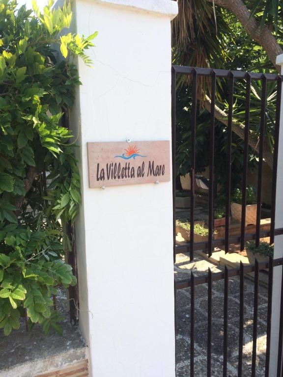 a gate with a sign that reads la wildoria atma at La Villetta al Mare in Porto Cesareo