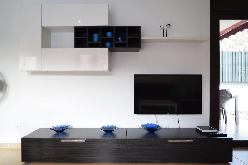 Televízia a/alebo spoločenská miestnosť v ubytovaní Mocan Perfect Stay