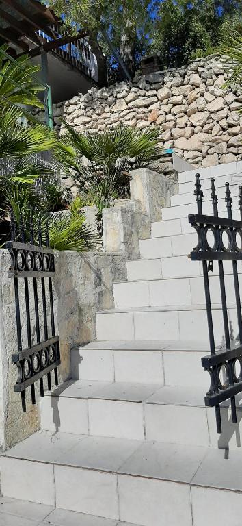 a set of white stairs with black railing at Apartment Nono Ivo in Vis