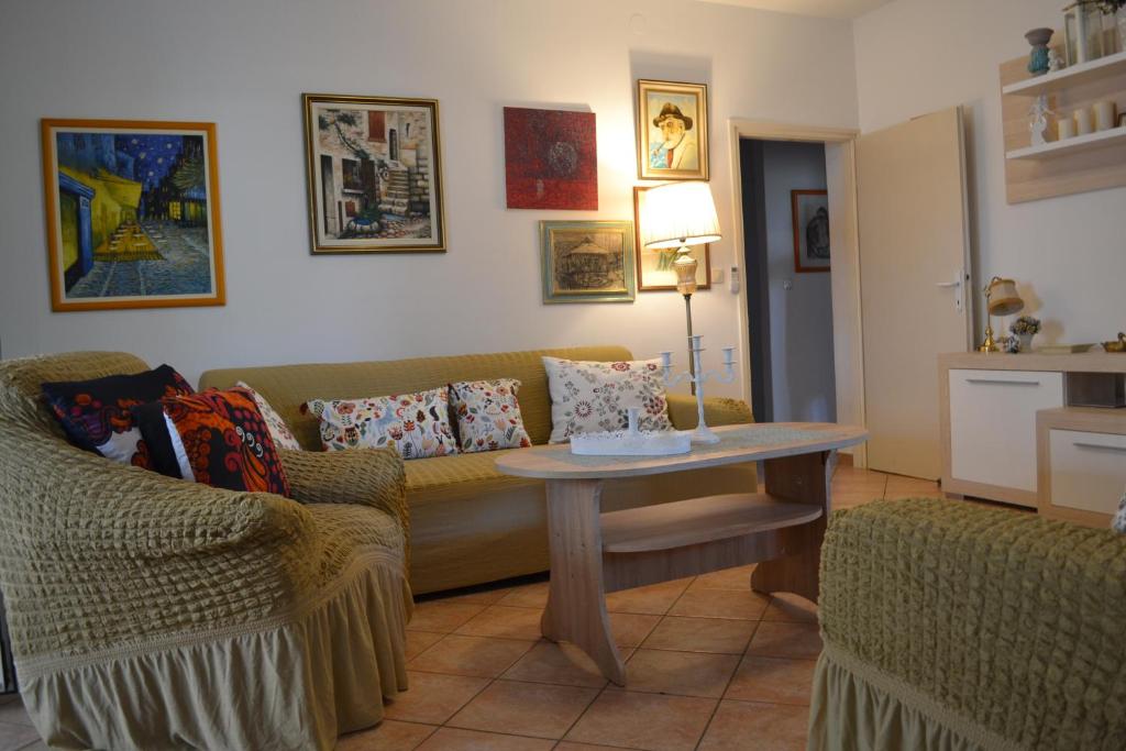 a living room with a couch and a table at Apartments Lucija in Srima