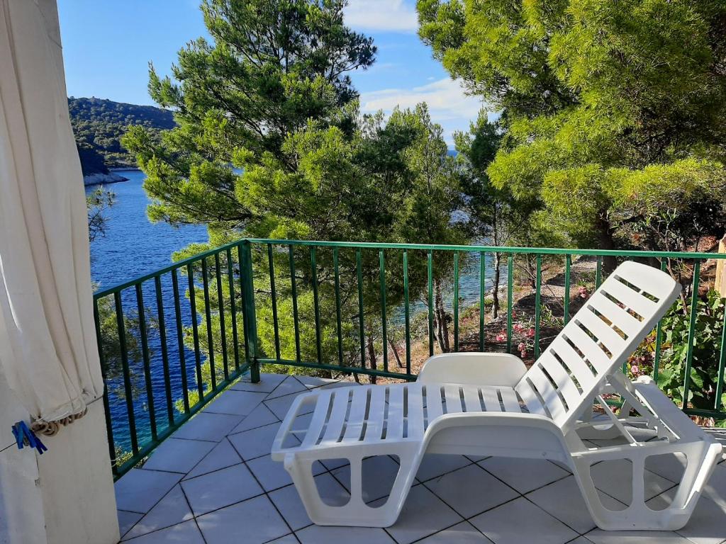a balcony with two white chairs and a view of the water at Apartment Nono Ivo in Vis