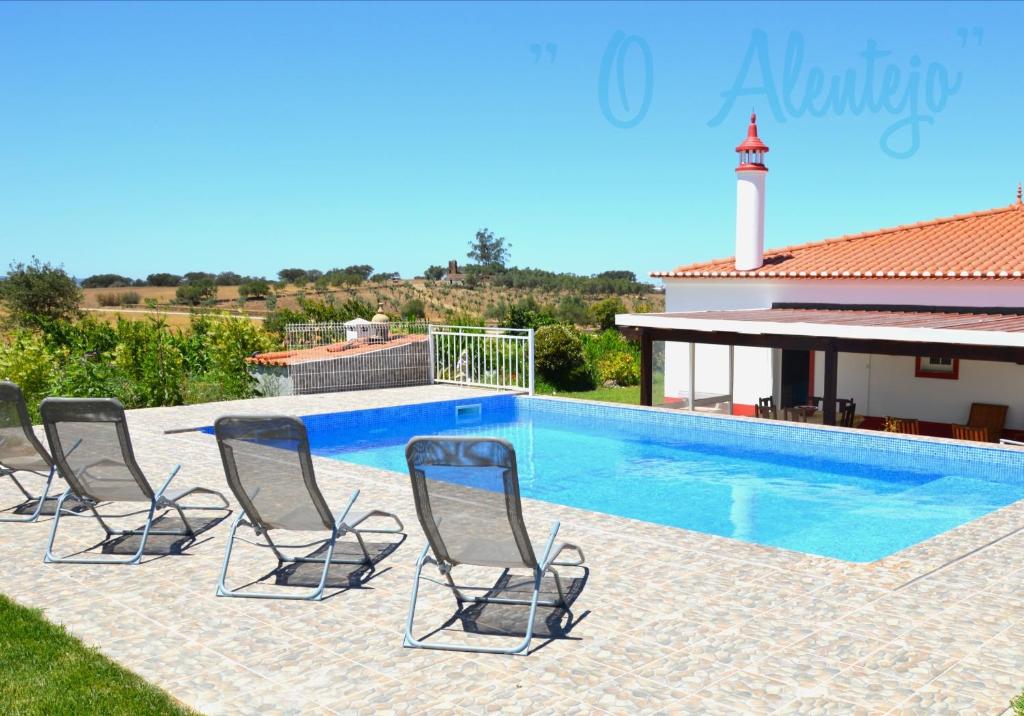 a group of chairs sitting next to a swimming pool at Monte O Alentejo in Ourique