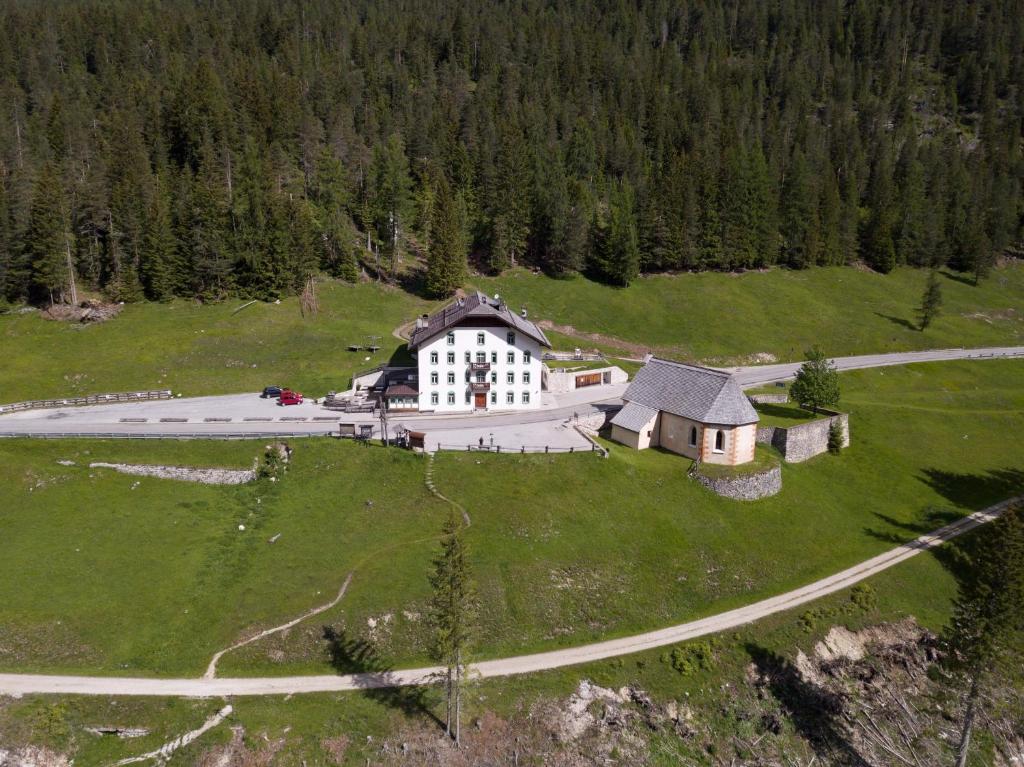 an aerial view of a large building on a green field at Ristorante Rifugio Ospitale in Cortina dʼAmpezzo