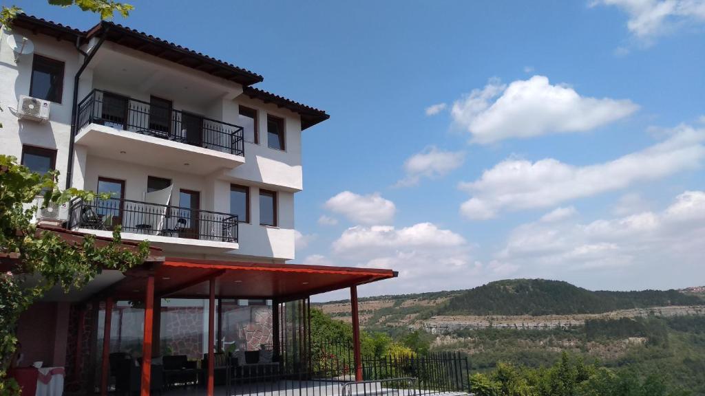 a building with a view of the mountains at Guest House Harmony in Veliko Tŭrnovo