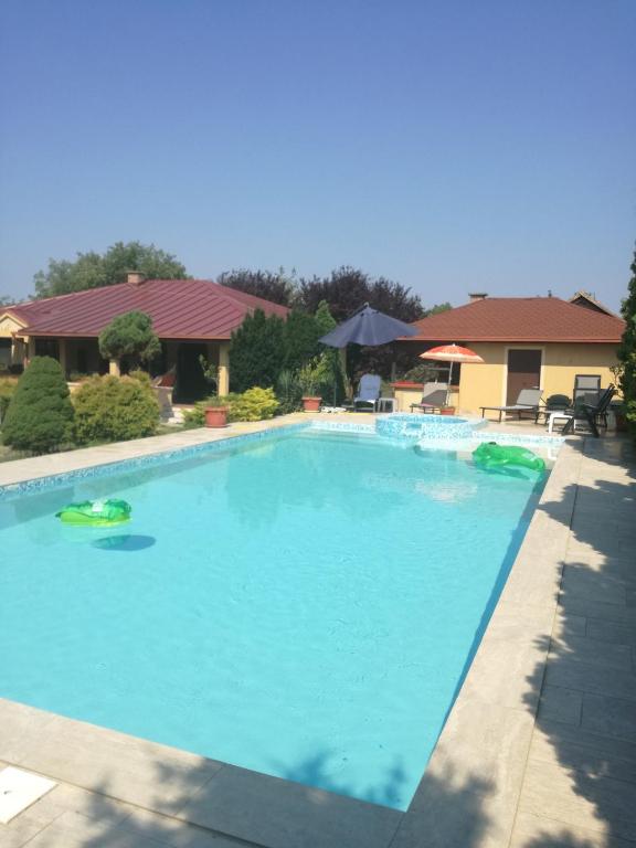 a large swimming pool with blue water at Kuća na dan Villa Holiday in Sakule