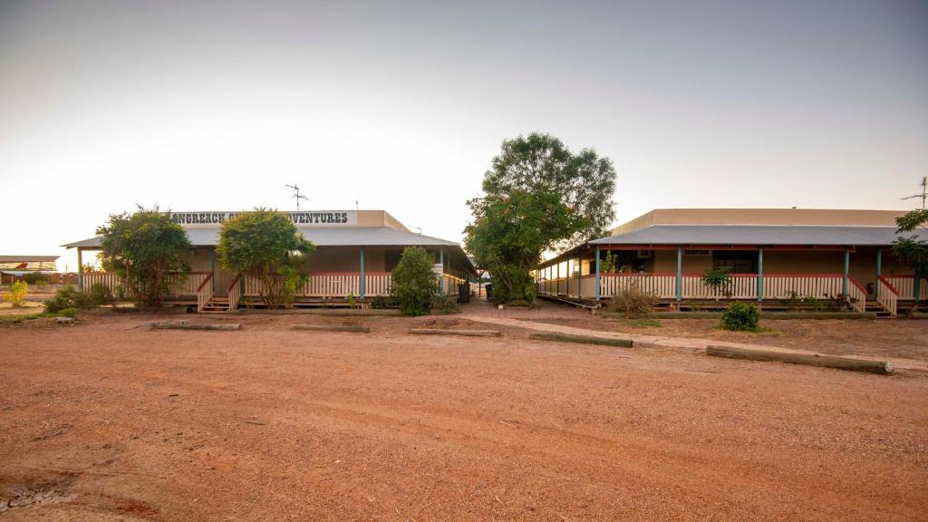 a building with a dirt road in front of it at STORK RD BUDGET ROOMS - PRIVATE ROOMS WITH SHARED BATHROOMS access to POOL in Longreach
