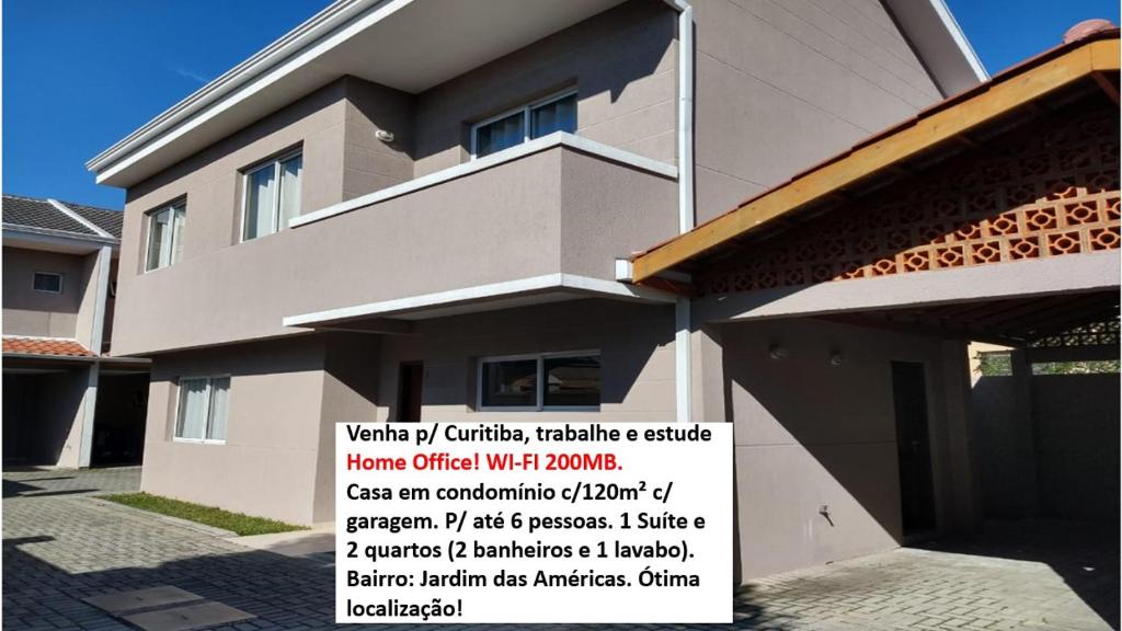 un edificio con un cartel en el costado en Casa Curitiba 120m² (1 Suíte e 2 Quartos) com garagem em condomínio en Curitiba