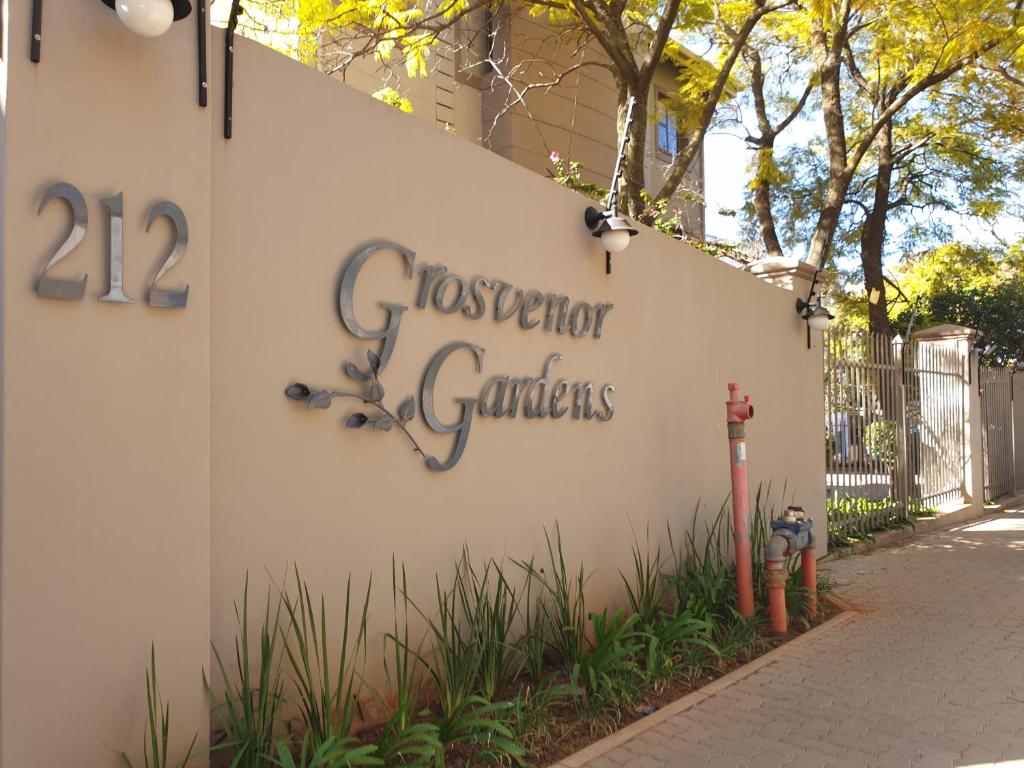 a sign on the side of a building with a fire hydrant at Grosvenor Apartments in Pretoria