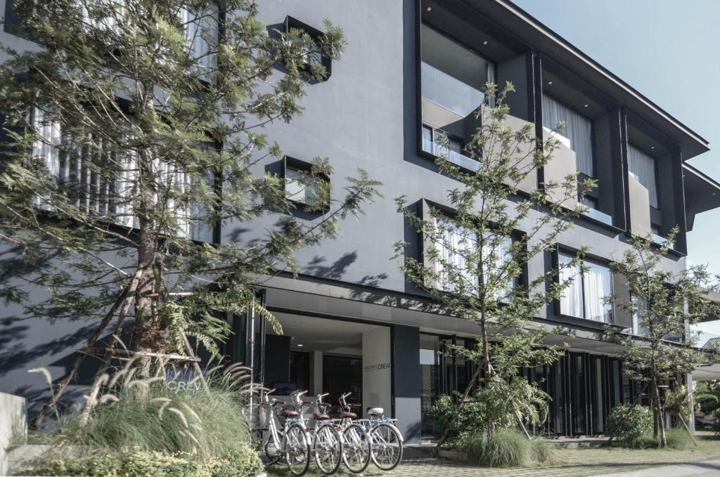 a building with bikes parked outside of it at CREW Hotel in Chiang Mai