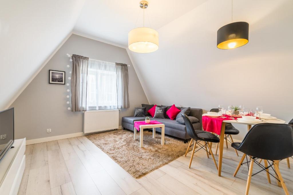 a living room with a couch and a table at ApartamentyGdanske EU - Golden in Gdańsk