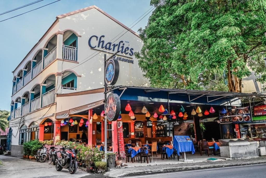 a restaurant with motorcycles parked in front of it at Sugar and Spice Inn in Kata Beach