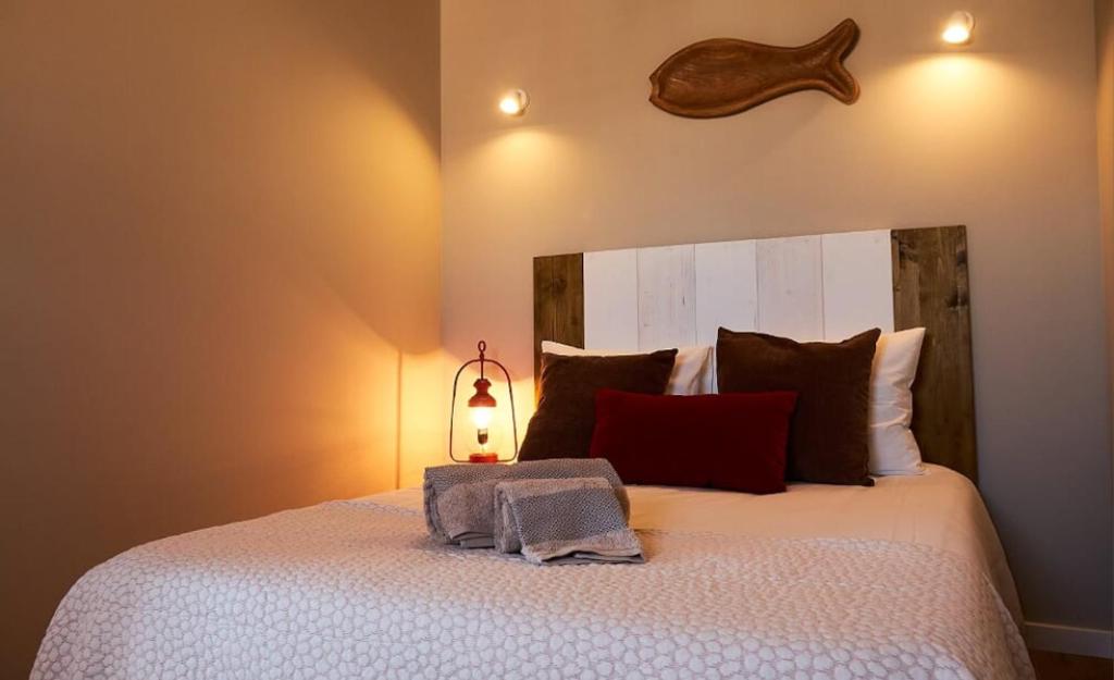 a bedroom with a large bed with a lamp on it at Velha 34 in Albufeira