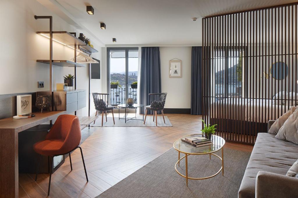 a living room with a couch and a table at Hotel SANSEbay in Donostia-San Sebastián