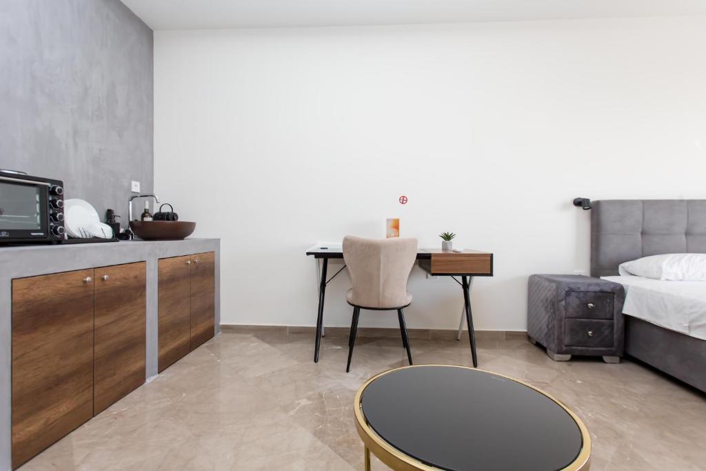 a bedroom with a bed and a table and a desk at Skyroof SKG in Thessaloniki