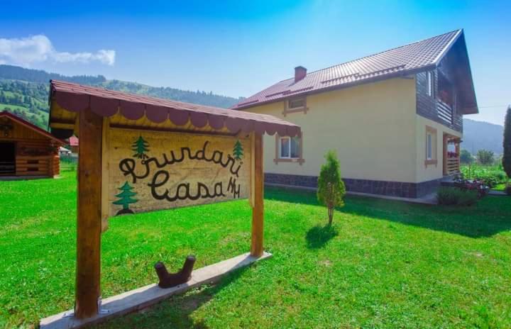 a sign in a yard in front of a house at Casa Prundari Nicu și Mirela in Poiana Teiului