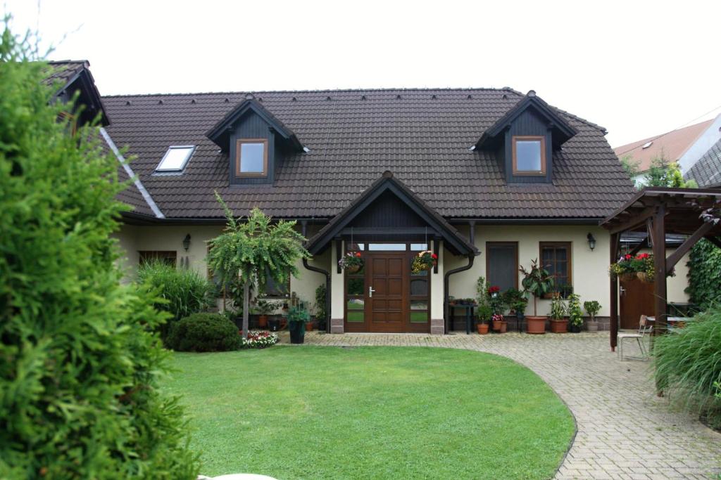 a house with a green lawn in front of it at Ubytovani Zdarske vrchy in Světnov