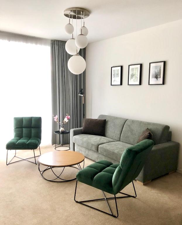 a living room with a couch and two chairs at Hrebienok C217 in Starý Smokovec