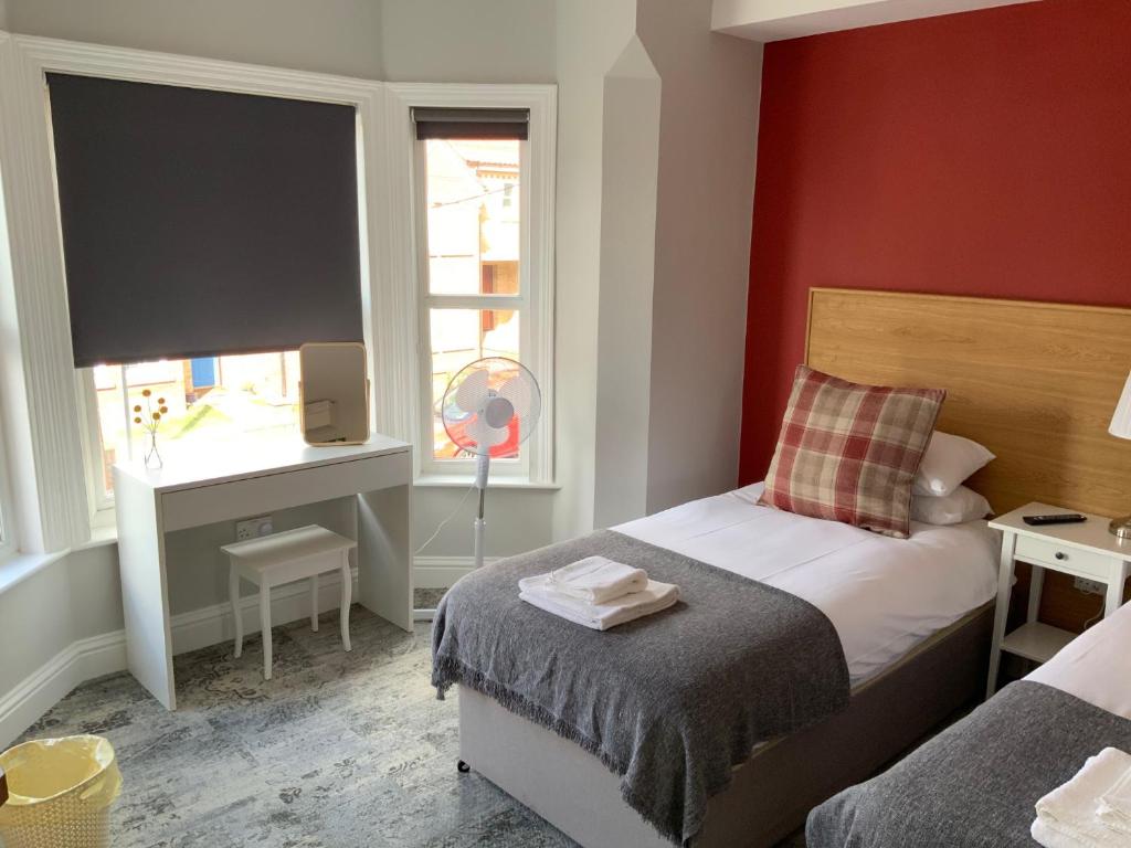 a small bedroom with a bed and a window at 8 Aspland Road in Norwich