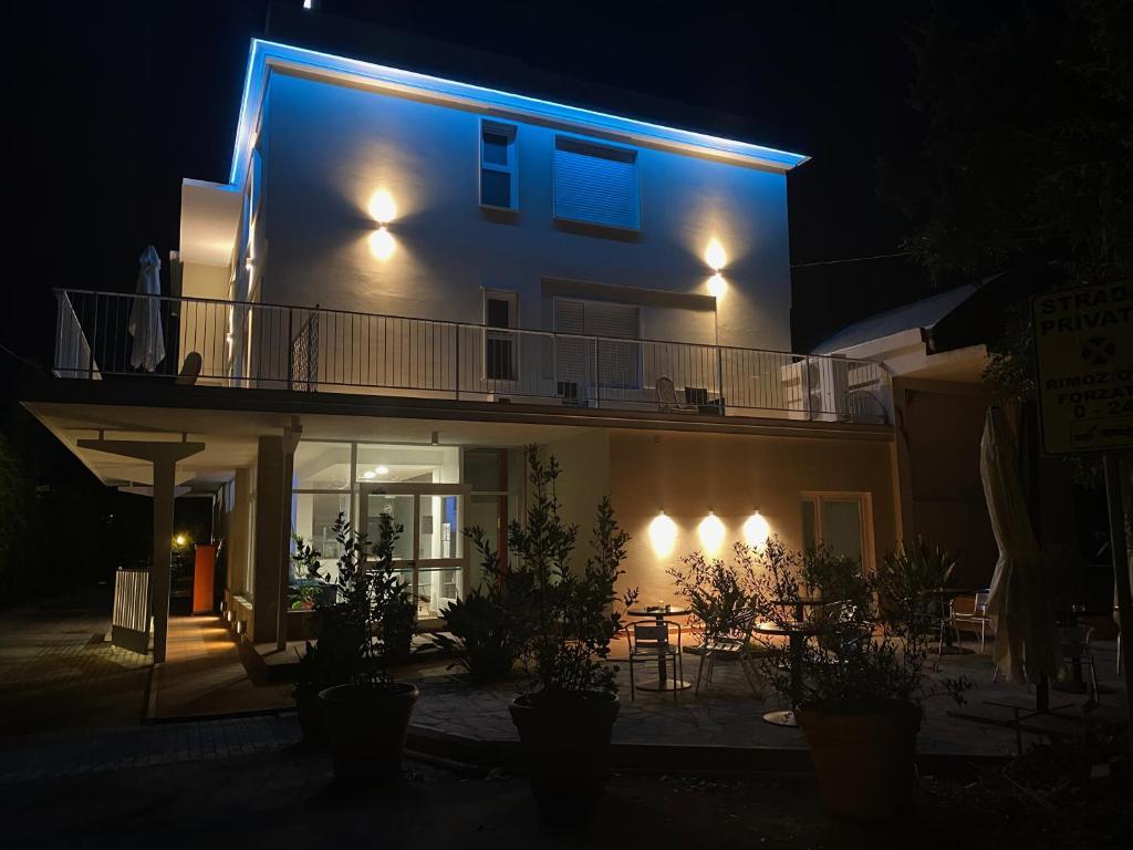 a house lit up at night with blue lights at Acquaviva Experience B&B in San Vincenzo