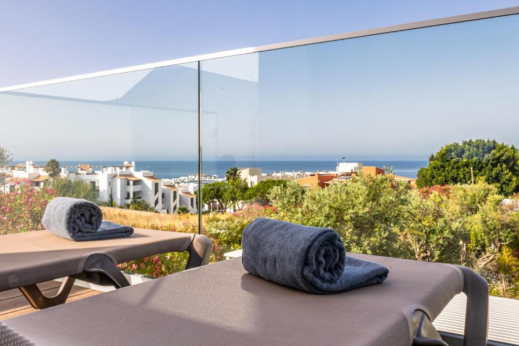 a balcony with a table and chairs with a view of the ocean at Lagos Atlantic Hotel in Lagos