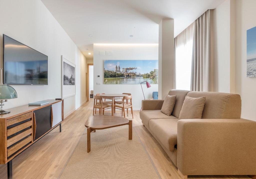 a living room with a couch and a table at El Museo Suites in Málaga