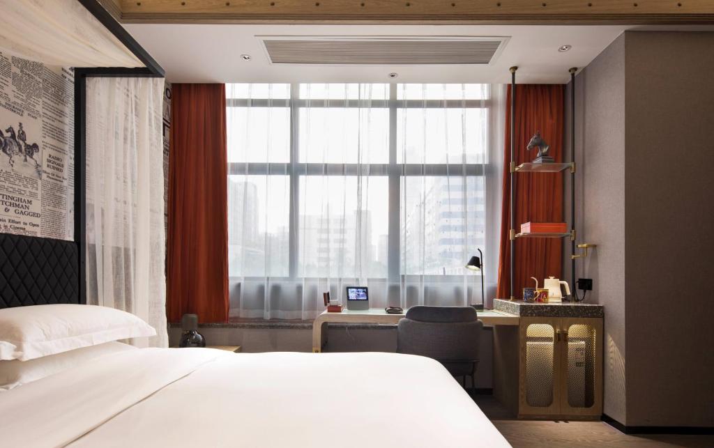 Postel nebo postele na pokoji v ubytování Arthur Hotel Zhujiang New Town Guangzhou-Pazhou Exhibition Center Branch