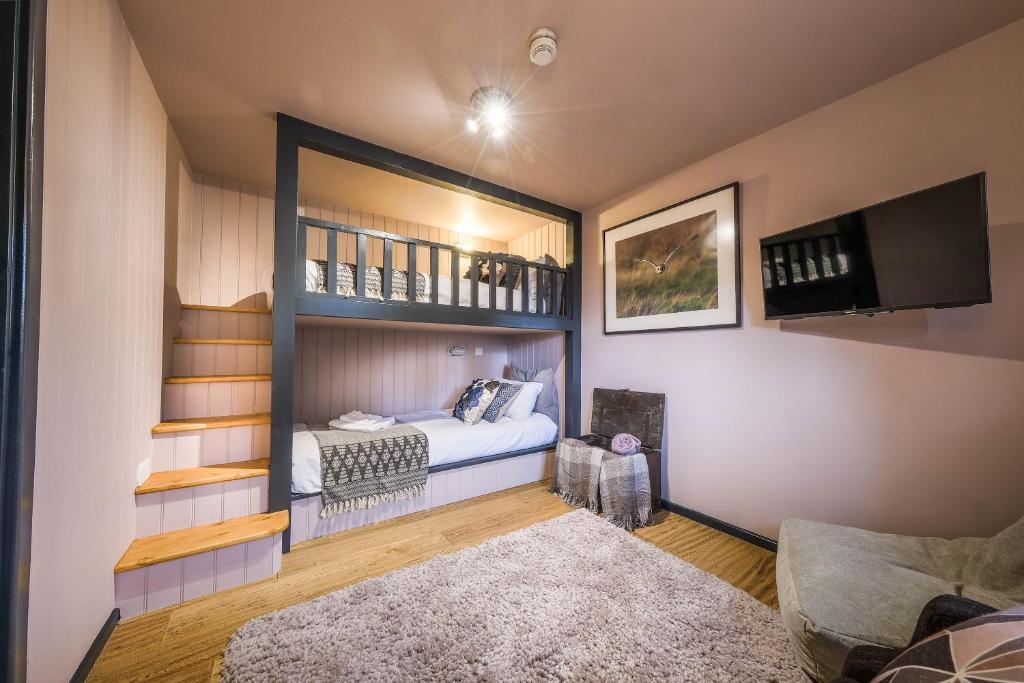 a bedroom with a bed and a tv in a room at The Westleton Crown in Westleton