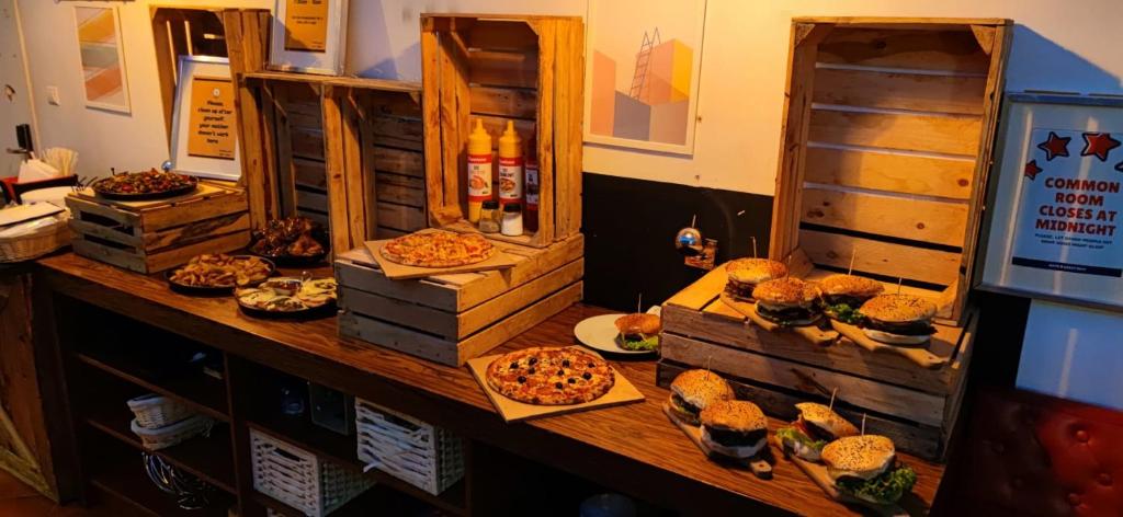 a table with many different types of food on it at Greg&Tom Beer House Hostel in Krakow