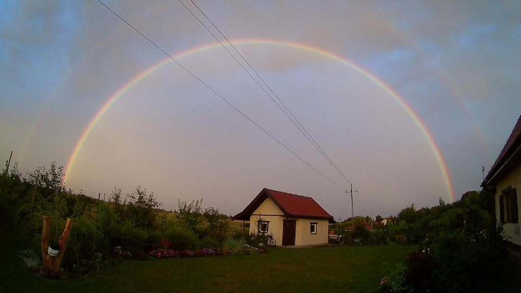 een regenboog in de lucht boven een huis bij Noclegi Pod Dachem pokoje gościnne domek letniskowy na wynajem agroturystyka wakacje in Sajzy