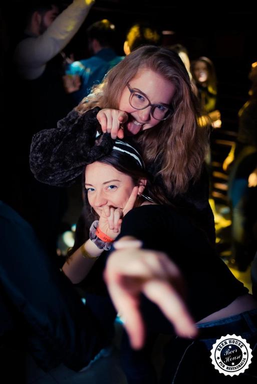 two women getting their hair done at a salon at Greg&Tom Beer House Hostel in Krakow