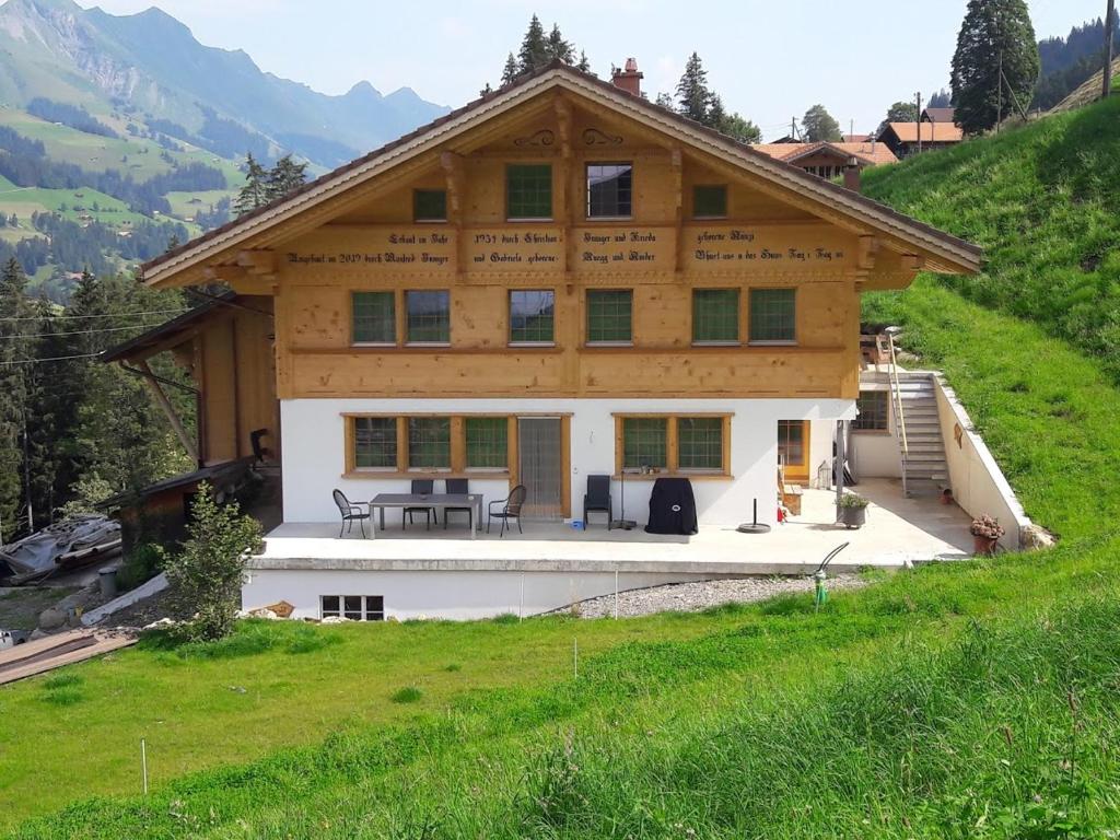 uma grande casa de madeira no topo de uma colina em Ferien in der Bergwelt von Adelboden em Adelboden