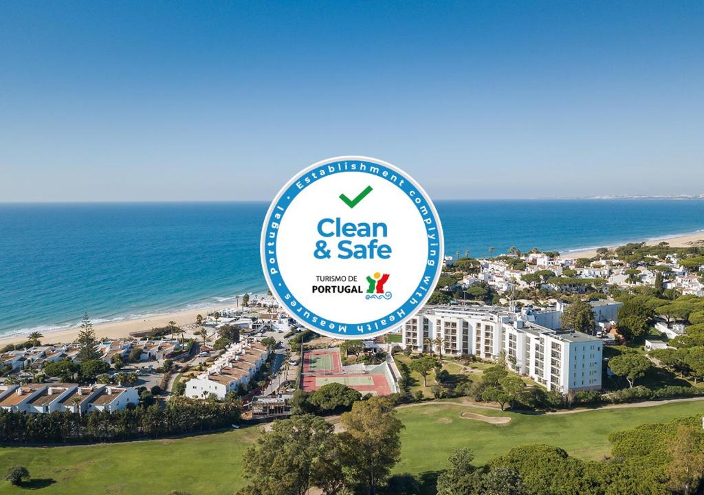 a sign for a clean and safe hotel next to the beach at Dona Filipa Hotel in Vale do Lobo