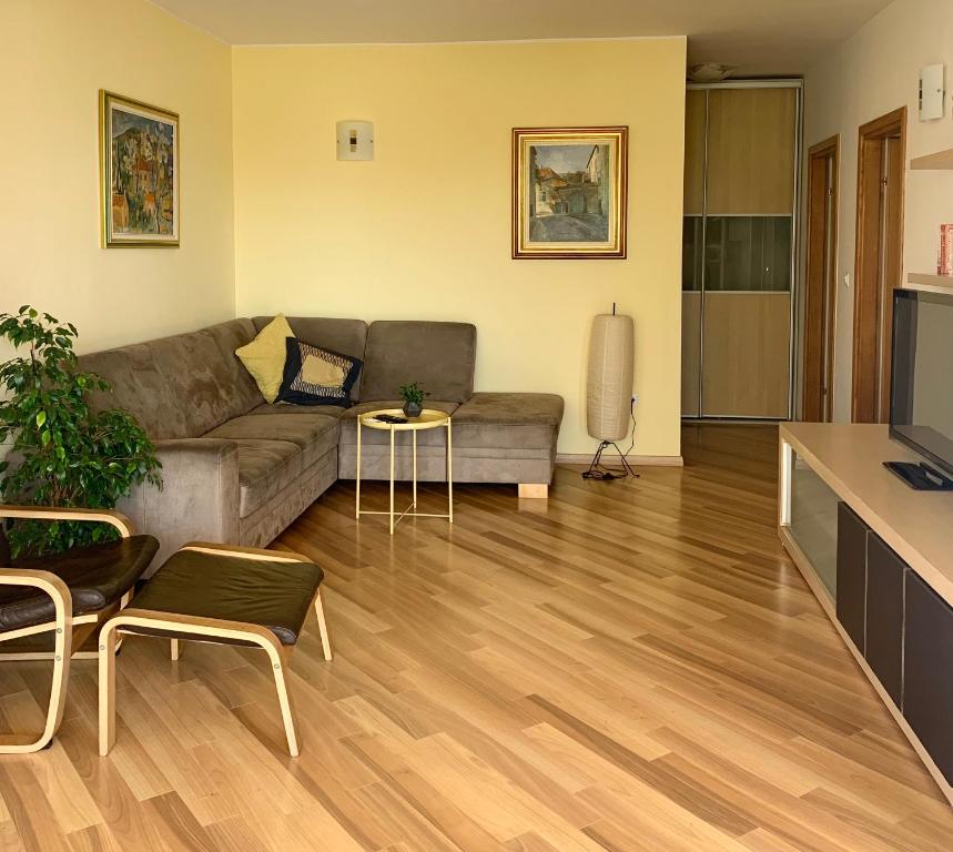 a living room with a couch and a table at City apartments Bobic in Cavtat